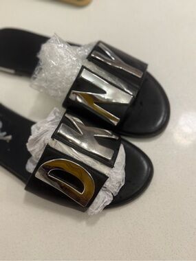 DKNY Black Slide Sandals with Silver Letter Accents